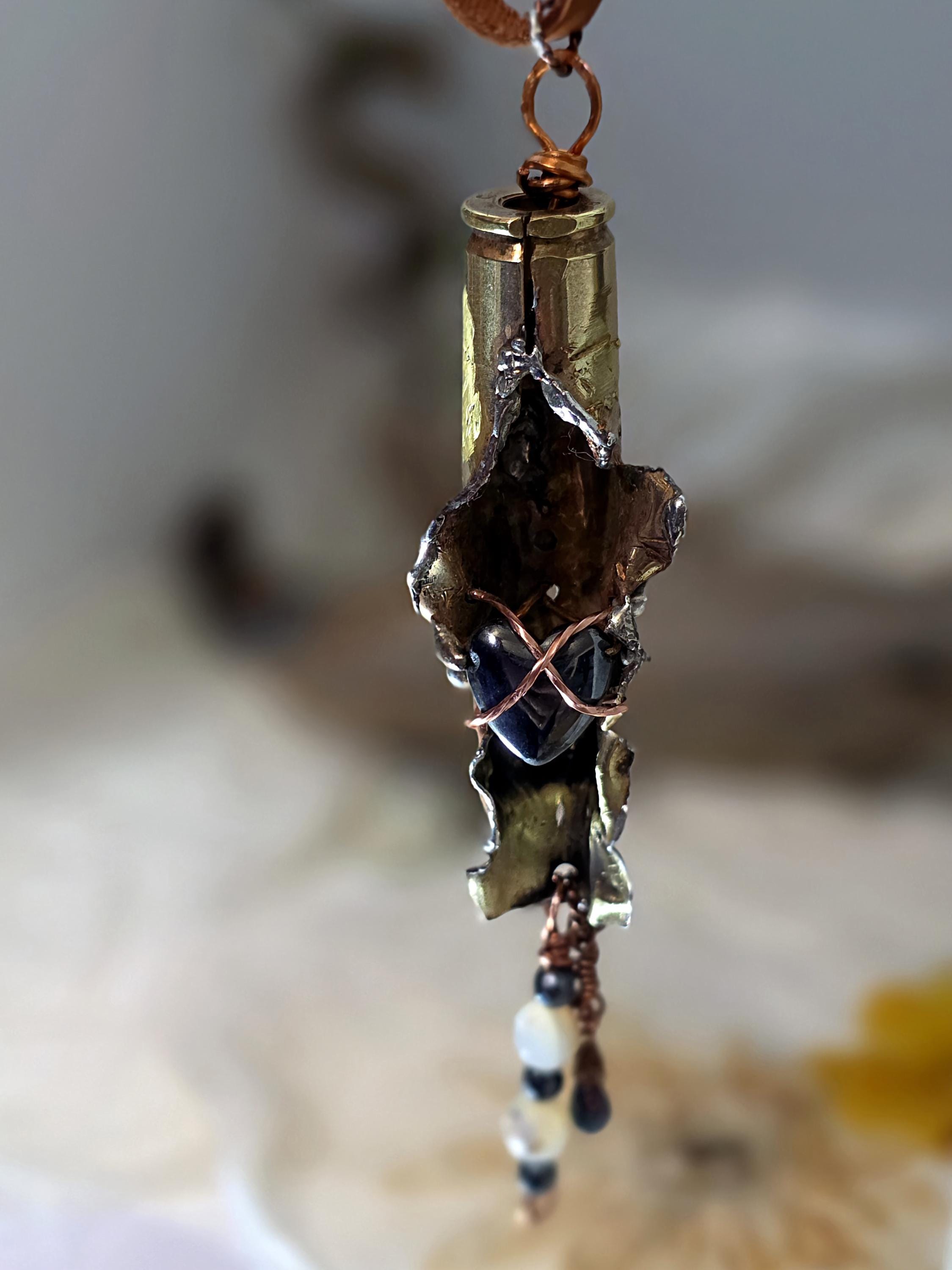 UNBROKEN “Center Mass” Shell Casing Pendant – Hematite Heart Necklace, Raw Metal Talisman, Survivor Jewelry, Rugged Artisan Pendant