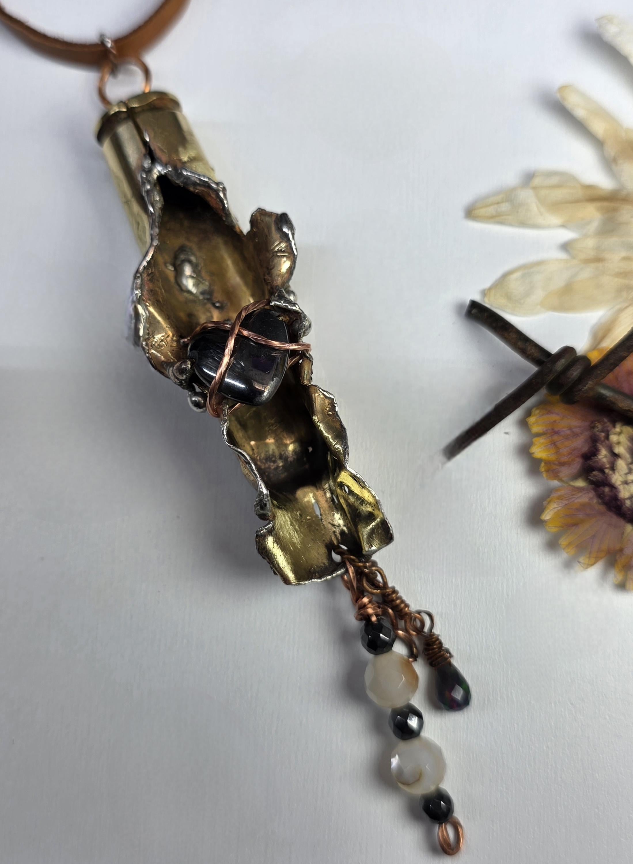 UNBROKEN “Center Mass” Shell Casing Pendant – Hematite Heart Necklace, Raw Metal Talisman, Survivor Jewelry, Rugged Artisan Pendant